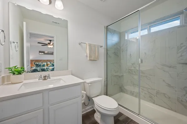 a bathroom with a sink toilet and shower