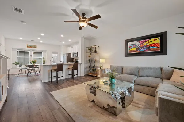 a living room with furniture and wooden floor