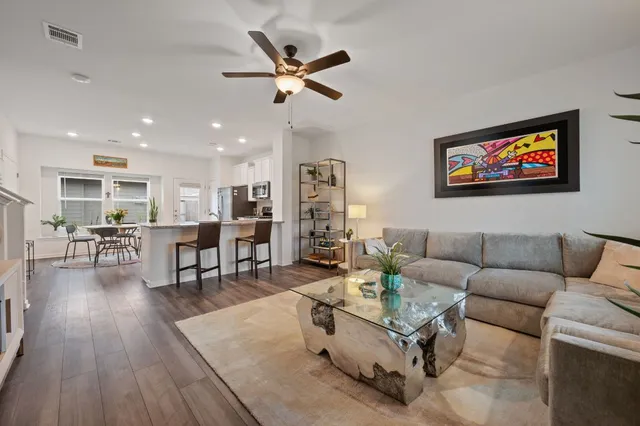 a living room with furniture and wooden floor