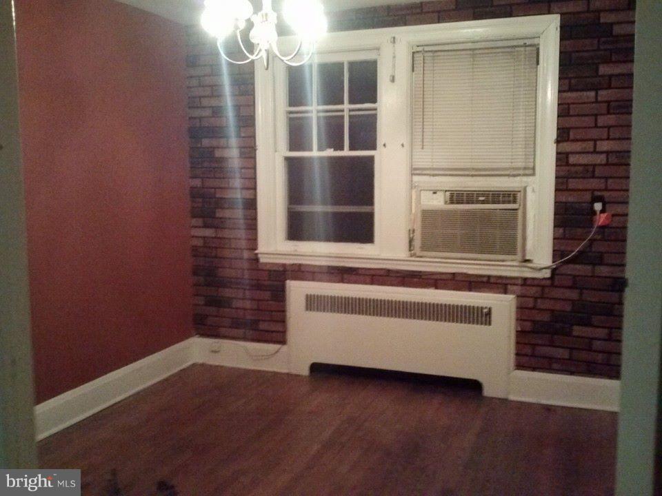 923 Calwell Road Baltimore, MD 21229 - Photo 8 of 14 a view of staircase with wooden floor and cabinet