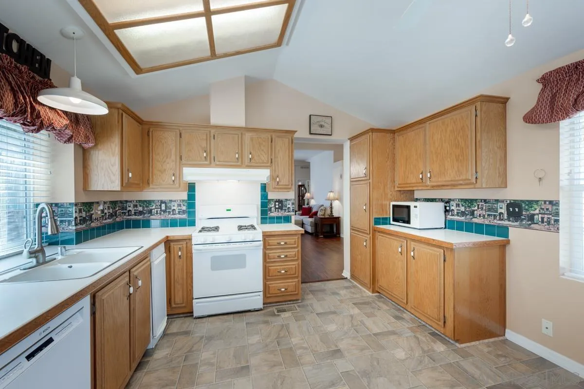 15935 Spring Oaks Road, Unit 122 El Cajon, CA 92021 - Photo 13 of 30 a kitchen with a stove cabinets and window