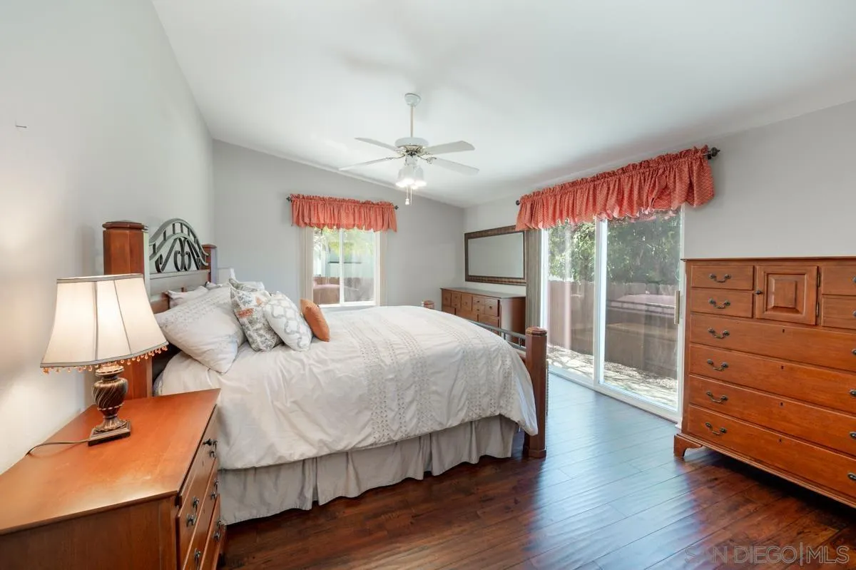 15935 Spring Oaks Road, Unit 122 El Cajon, CA 92021 - Photo 14 of 30 a bedroom with a bed and wooden floor