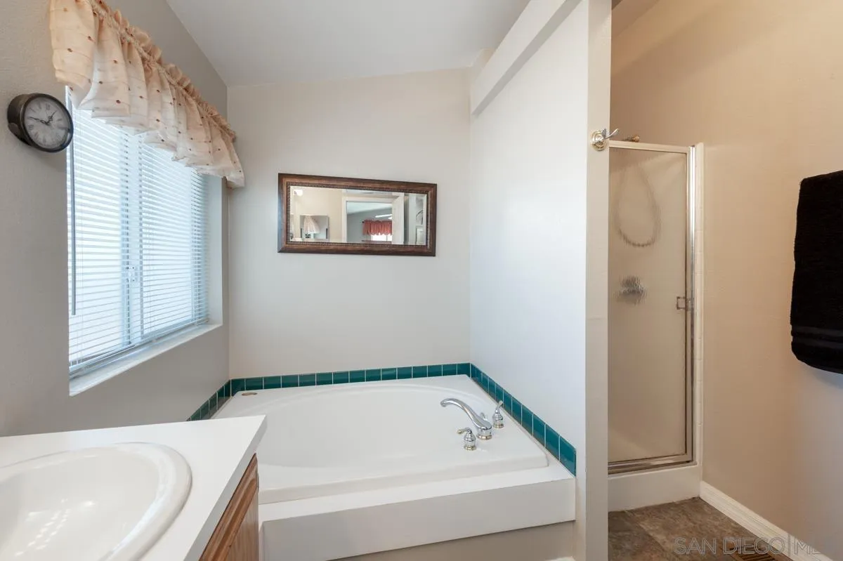 15935 Spring Oaks Road, Unit 122 El Cajon, CA 92021 - Photo 18 of 30 a bathroom with a bathtub and a window