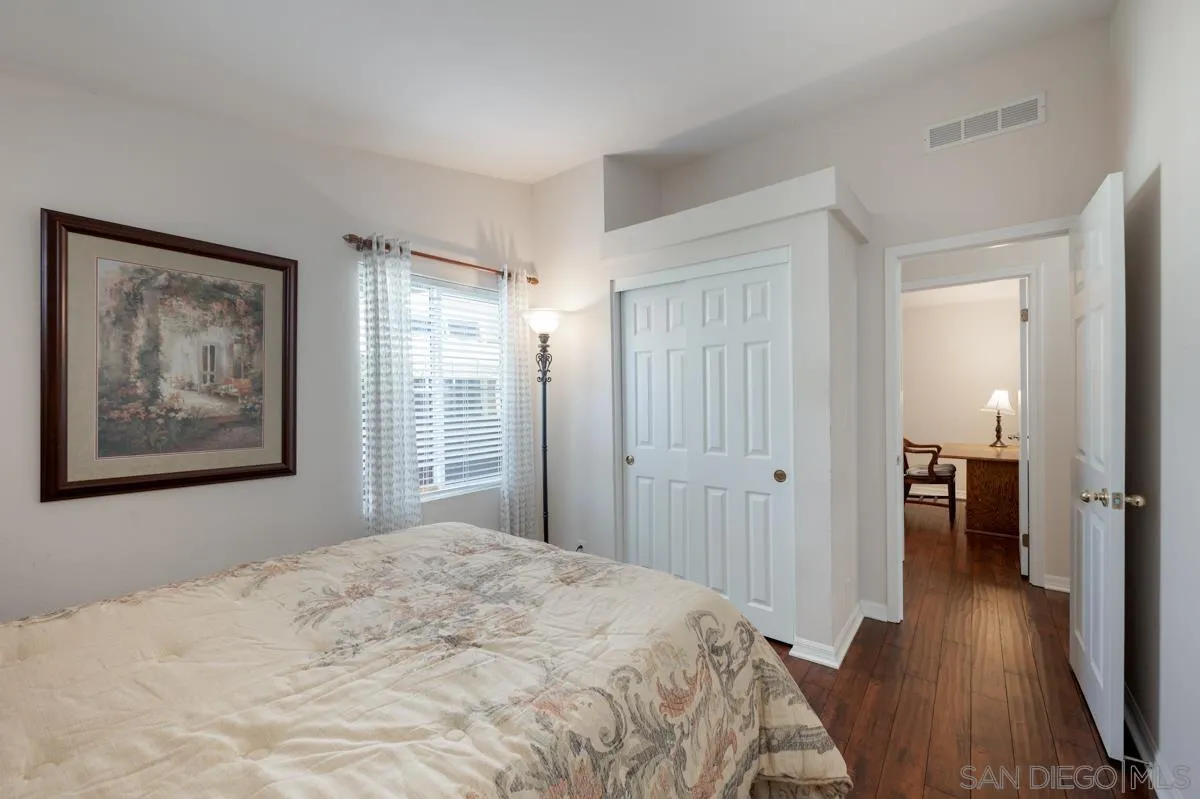 15935 Spring Oaks Road, Unit 122 El Cajon, CA 92021 - Photo 20 of 30 a bedroom with a bed and wooden floor