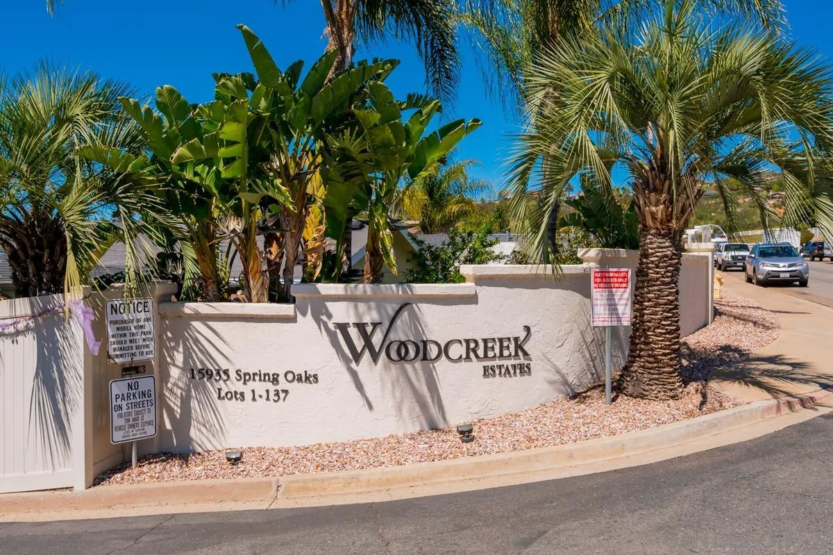 15935 Spring Oaks Road, Unit 122 El Cajon, CA 92021 - Photo 2 of 30 a view of outdoor space with sign board and palm trees