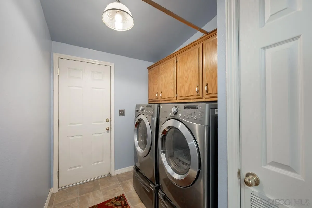 15935 Spring Oaks Road, Unit 122 El Cajon, CA 92021 - Photo 24 of 30 a view of a hallway with washer and dryer