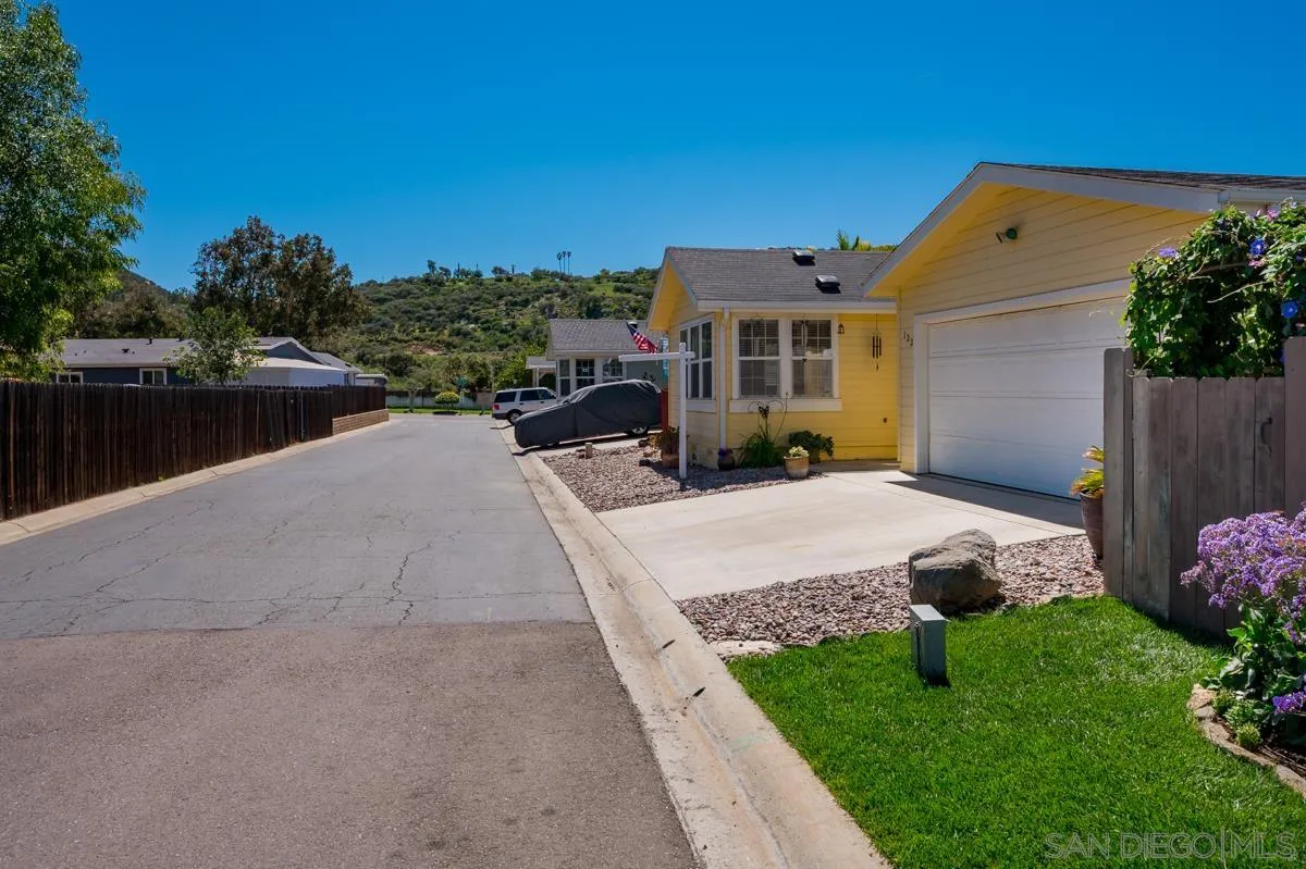 15935 Spring Oaks Road, Unit 122 El Cajon, CA 92021 - Photo 4 of 30 a front view of a house with a yard and lake view