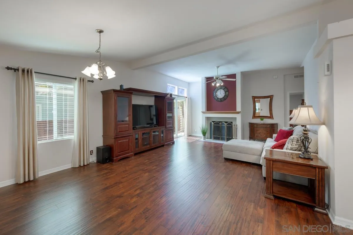15935 Spring Oaks Road, Unit 122 El Cajon, CA 92021 - Photo 5 of 30 a living room with fireplace furniture and a wooden floor