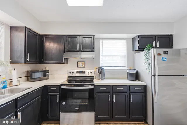 a kitchen with a refrigerator and a sink