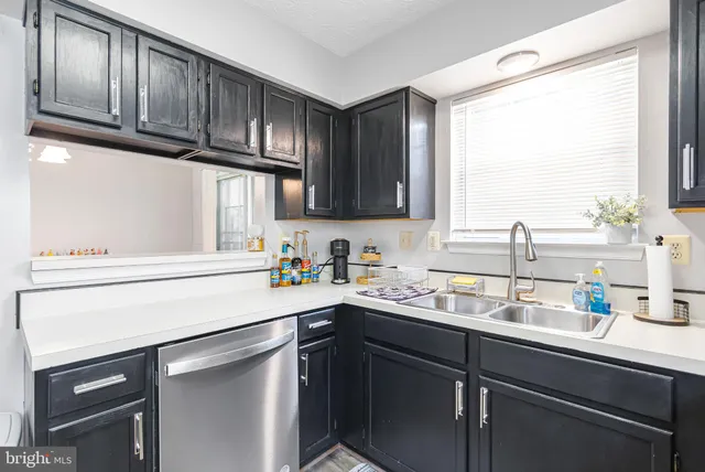 a kitchen with a sink cabinets and window