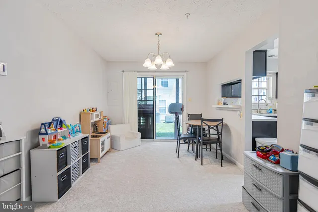 a view of a dining room with furniture and a chandelier