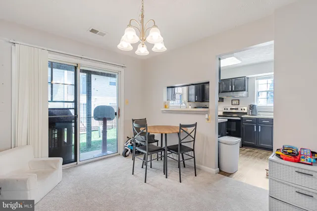a kitchen with a dining table and chairs