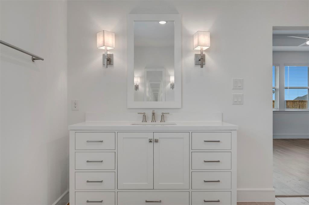 1004 Ashcroft Lane Justin, TX 76247 - Photo 14 of 39 a bathroom with a sink vanity and mirror