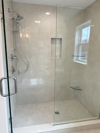 a bathroom with a glass shower door