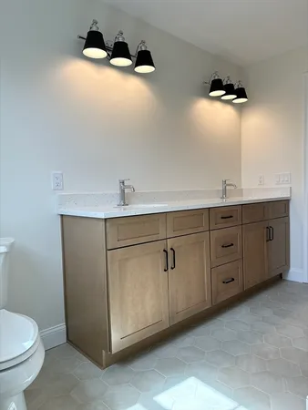 a bathroom with a double vanity sink and mirror