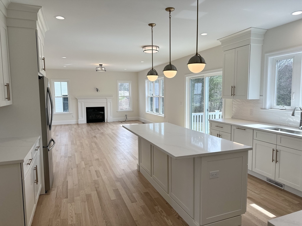 2 Libbey Lane Grafton, MA 01536 - Photo 5 of 18 a large kitchen with stainless steel appliances a large center island wooden floor sink and a window