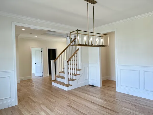 a view of a hallway with wooden floor and entryway