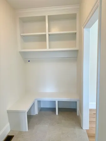 a view of room with white door and a cabinet