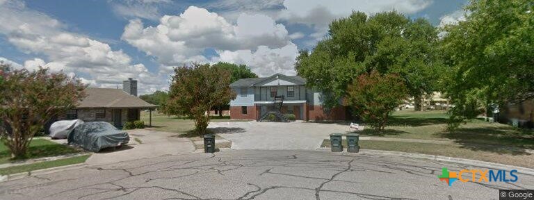 a view of a street with houses on both side