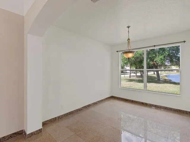 a view of an empty room with windows