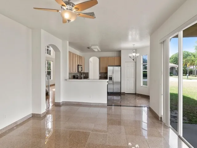 a view of a kitchen with a refrigerator and a sink