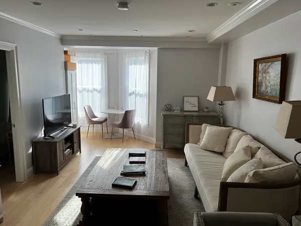 a living room with furniture a rug and a flat screen tv