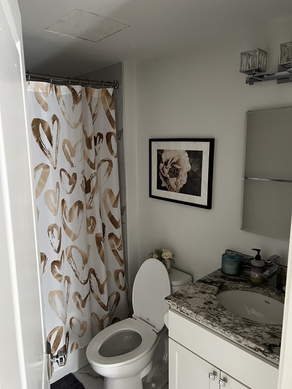296 Beacon Street, Unit 7 Boston, MA 02116 - Photo 15 of 21 a bathroom with a granite countertop toilet and a sink