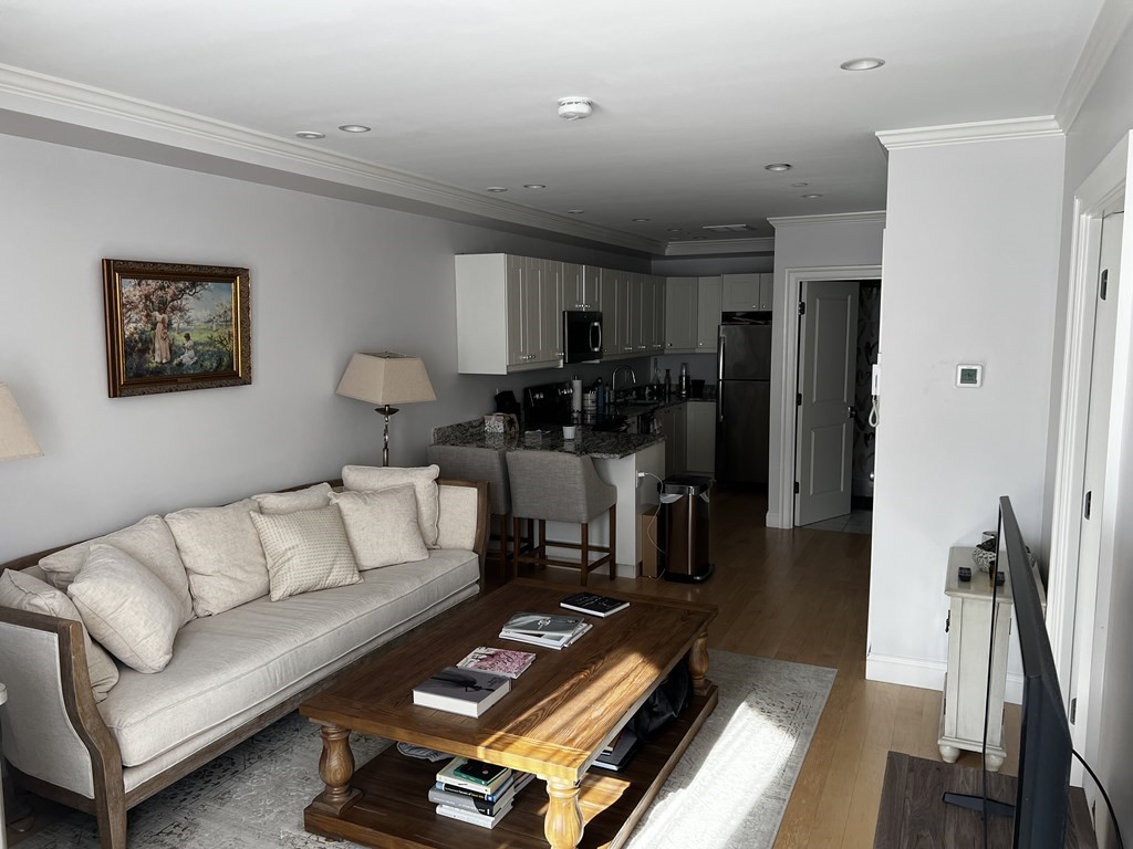 296 Beacon Street, Unit 7 Boston, MA 02116 - Photo 19 of 21 a living room with furniture and a wooden floor
