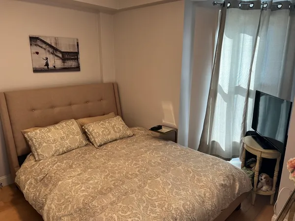 a bed sitting in a bedroom next to a window