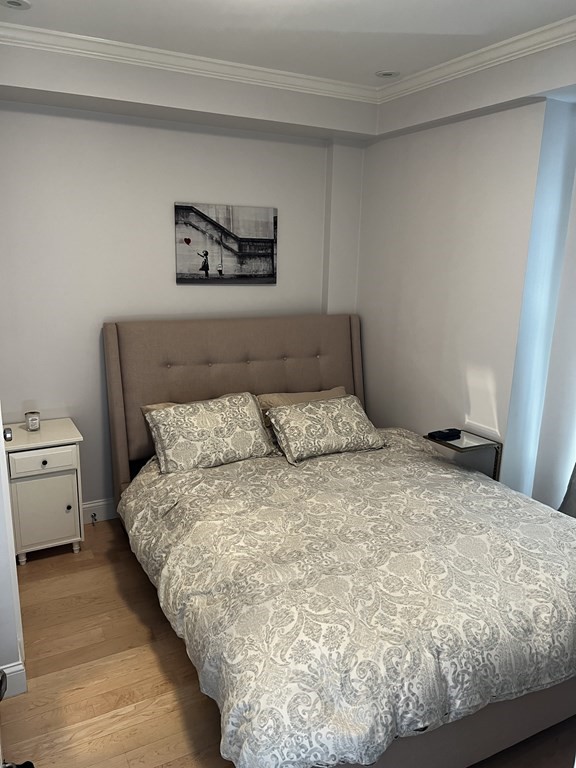 296 Beacon Street, Unit 7 Boston, MA 02116 - Photo 21 of 21 a large bed sitting in a bedroom next to a window