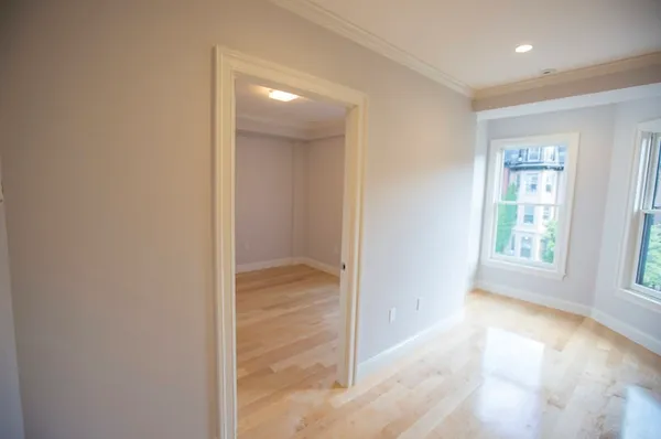 an empty room with windows and closet