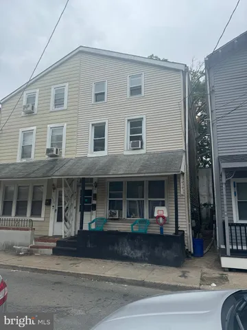 a front view of a house with a lots of windows and garage