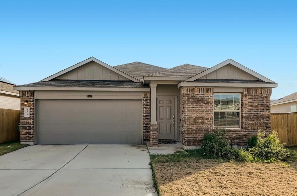 209 COSMOS Lane Jarrell, TX 76537 - Photo 1 of 1 a front view of a house with a garden