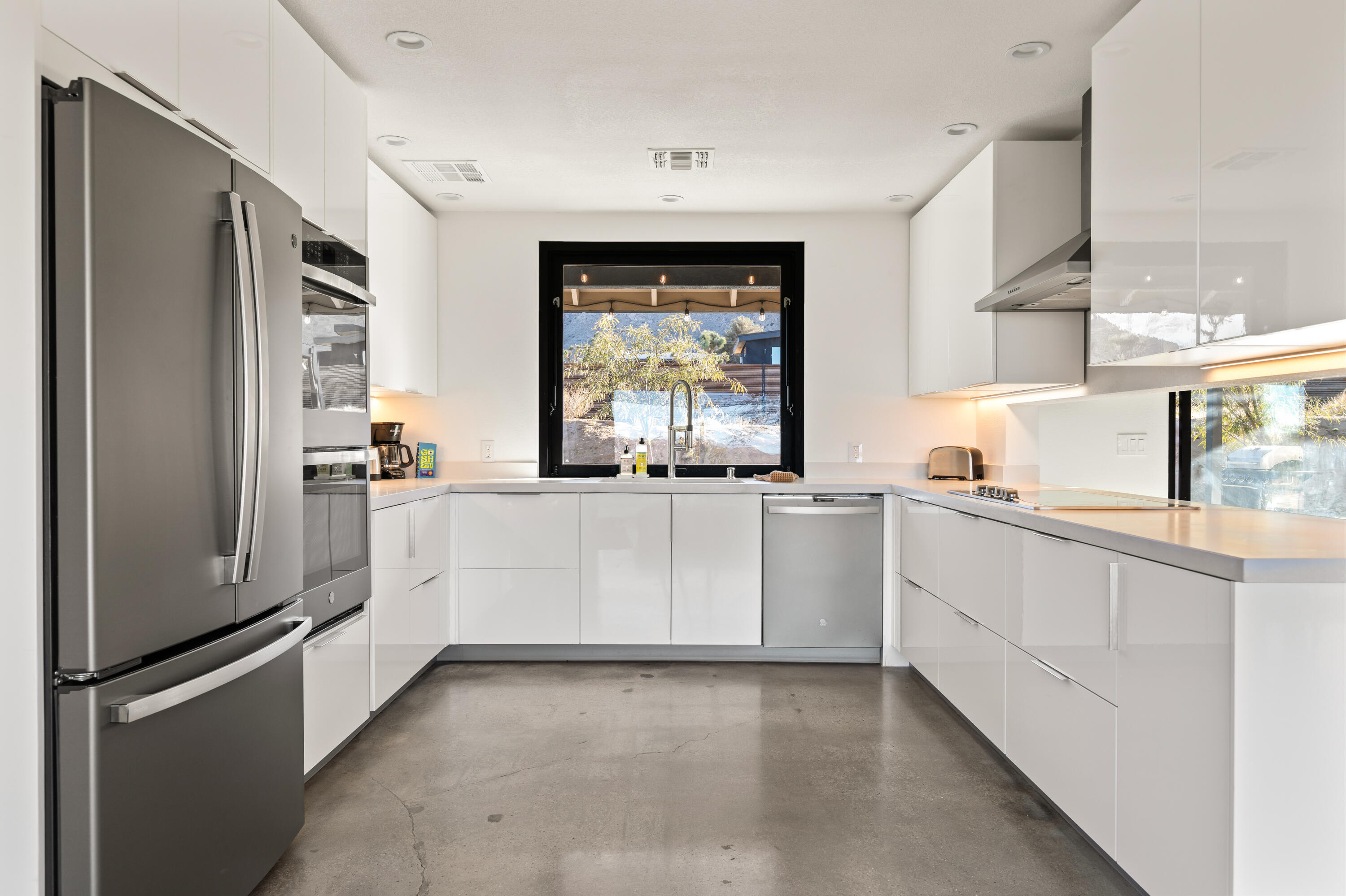 60633 Pueblo Trail Joshua Tree, CA 92252 - Photo 25 of 65 a kitchen with white cabinets and white appliances