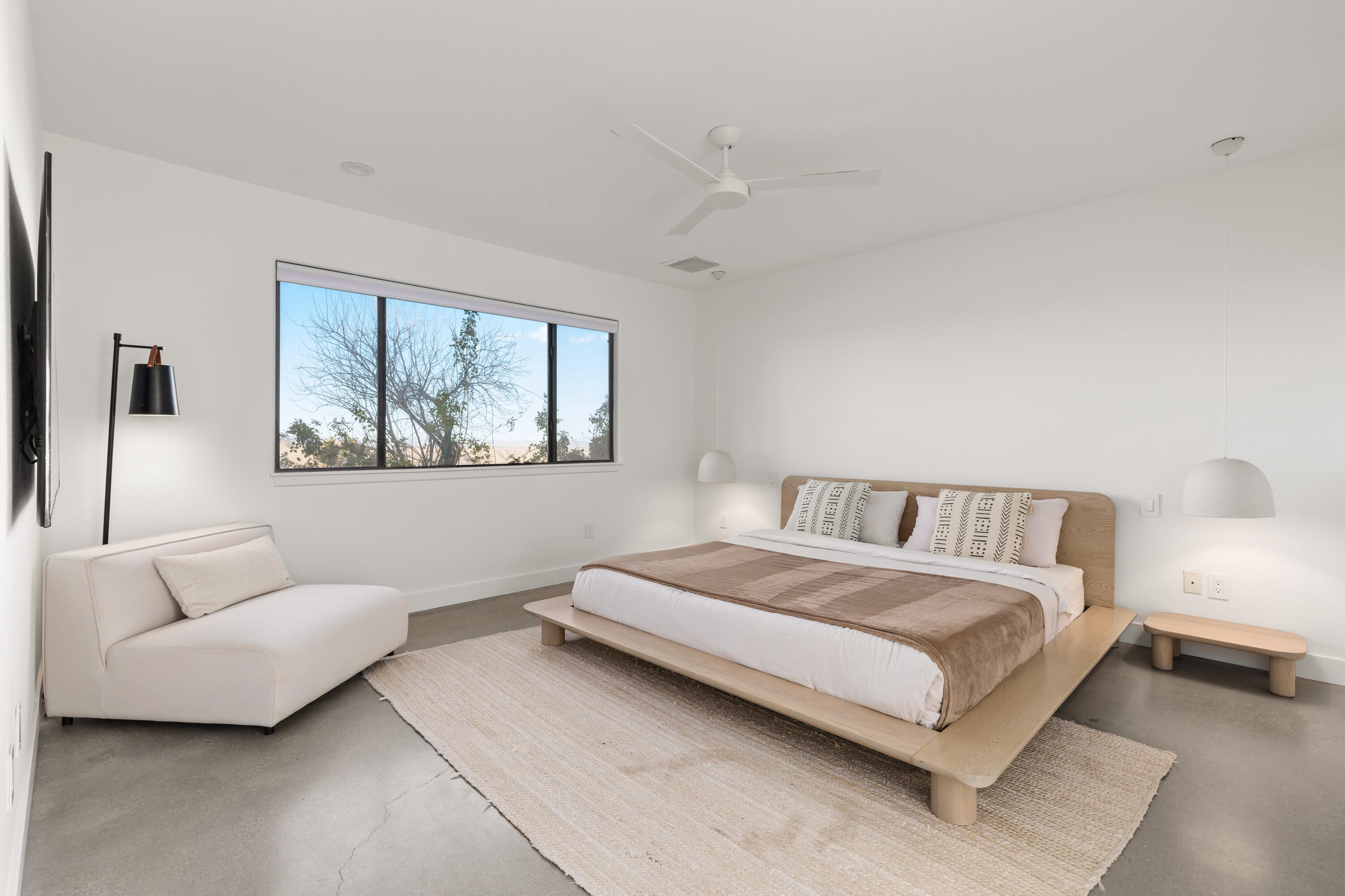 60633 Pueblo Trail Joshua Tree, CA 92252 - Photo 30 of 65 a spacious bedroom with a bed and a couch