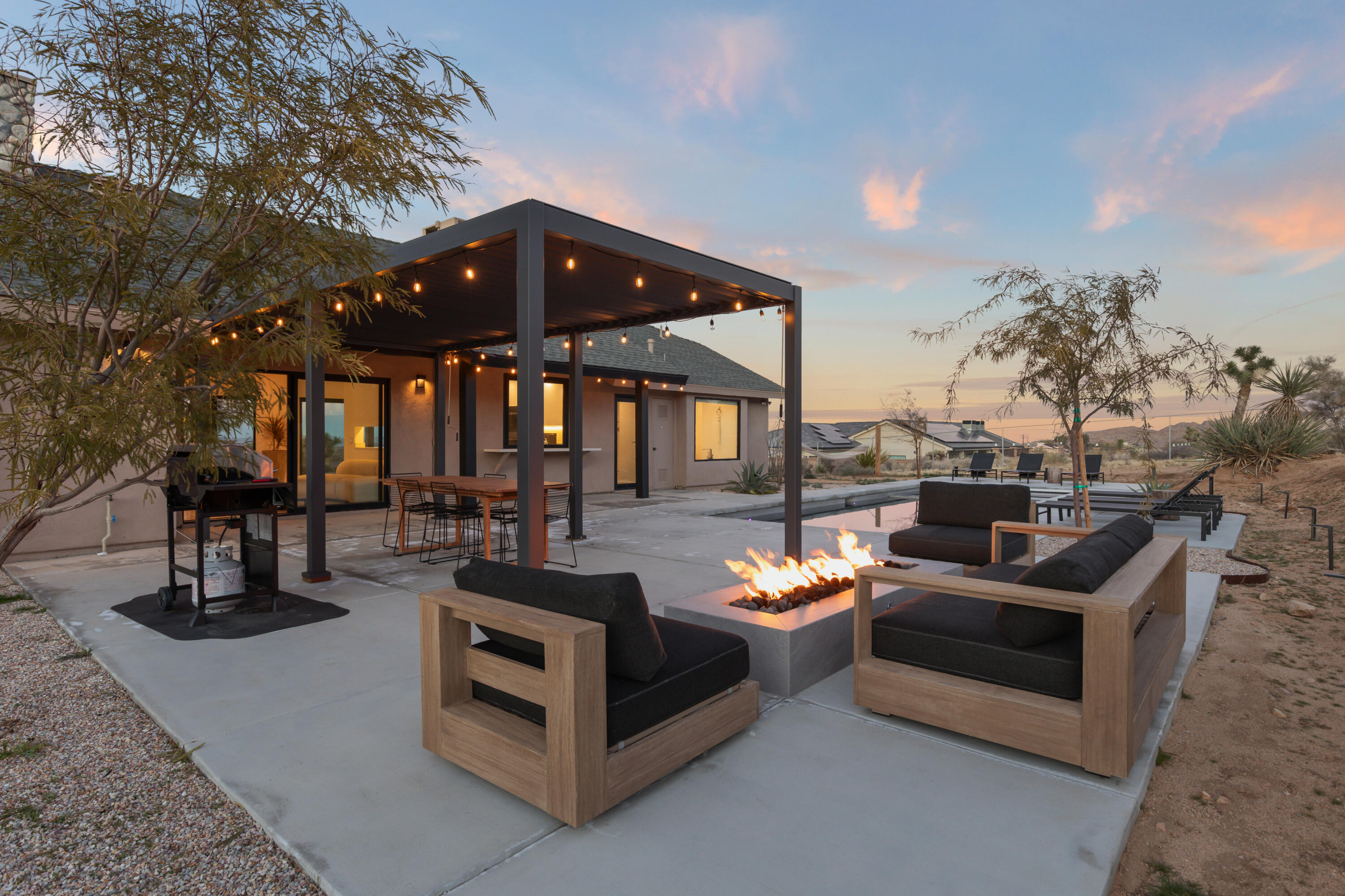 60633 Pueblo Trail Joshua Tree, CA 92252 - Photo 3 of 65 a view of a roof deck with couches and potted plants