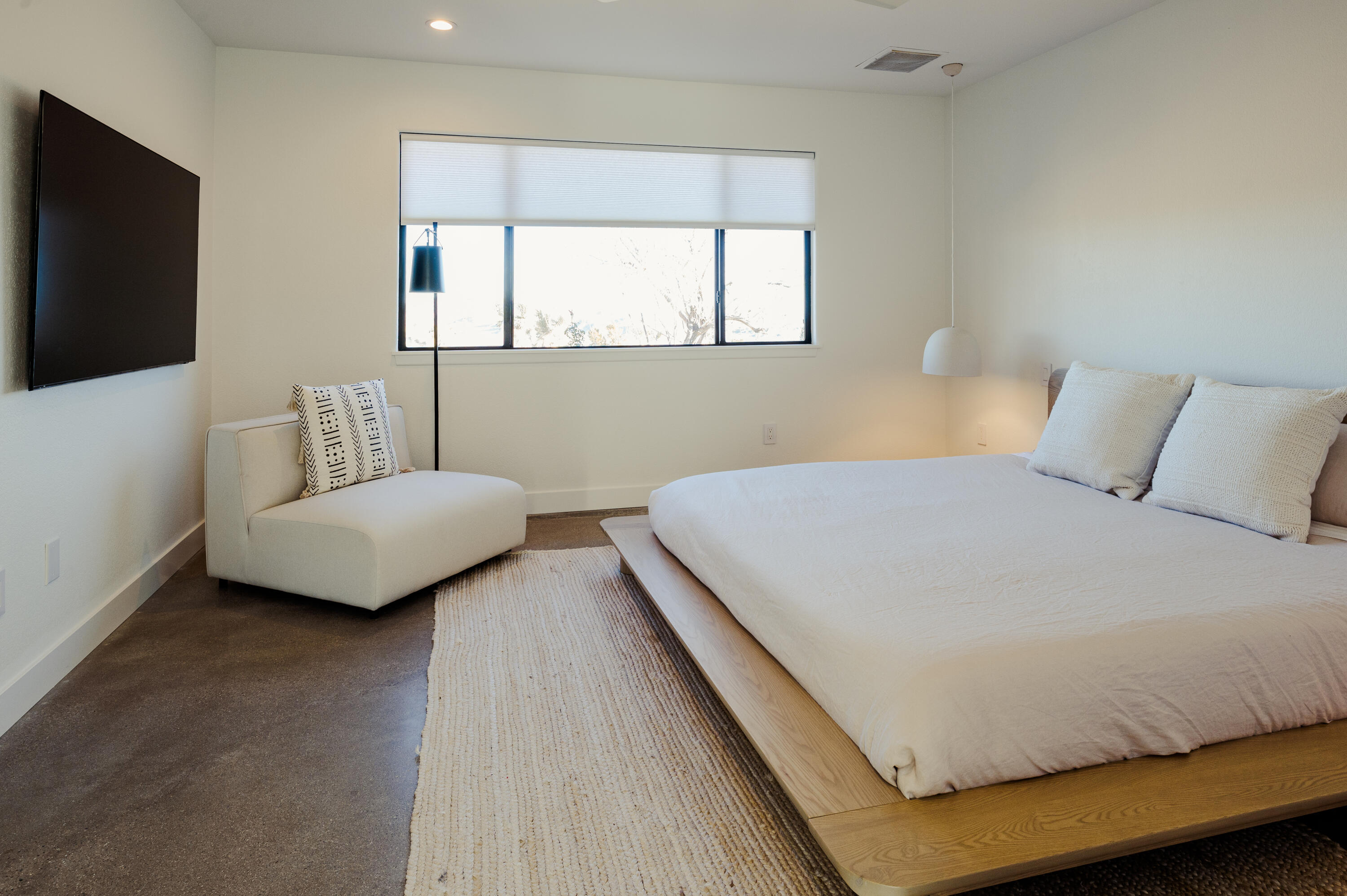 60633 Pueblo Trail Joshua Tree, CA 92252 - Photo 33 of 65 a bedroom with a bed and a flat screen tv