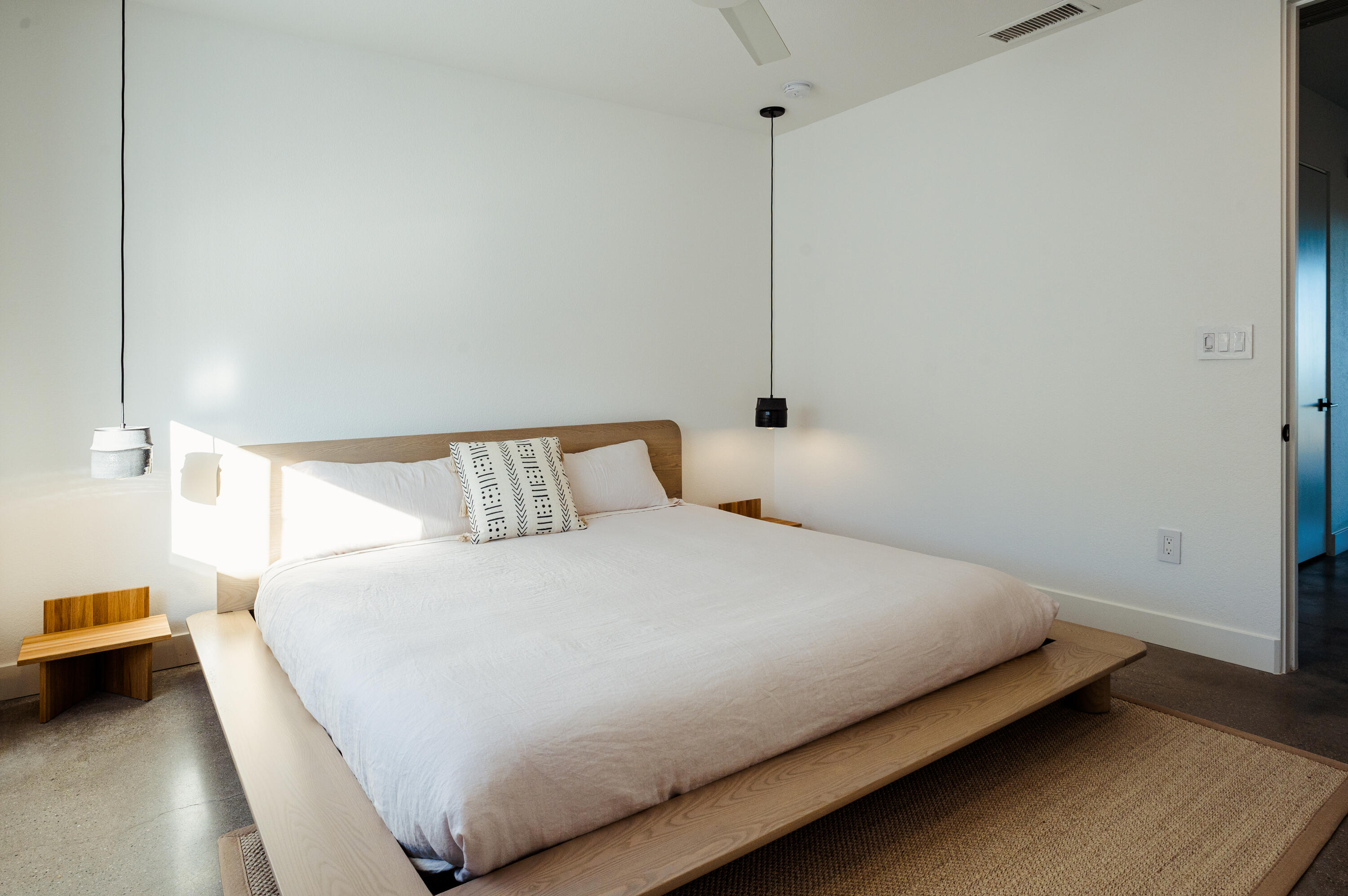 60633 Pueblo Trail Joshua Tree, CA 92252 - Photo 39 of 65 a bedroom with a bed and a night stand