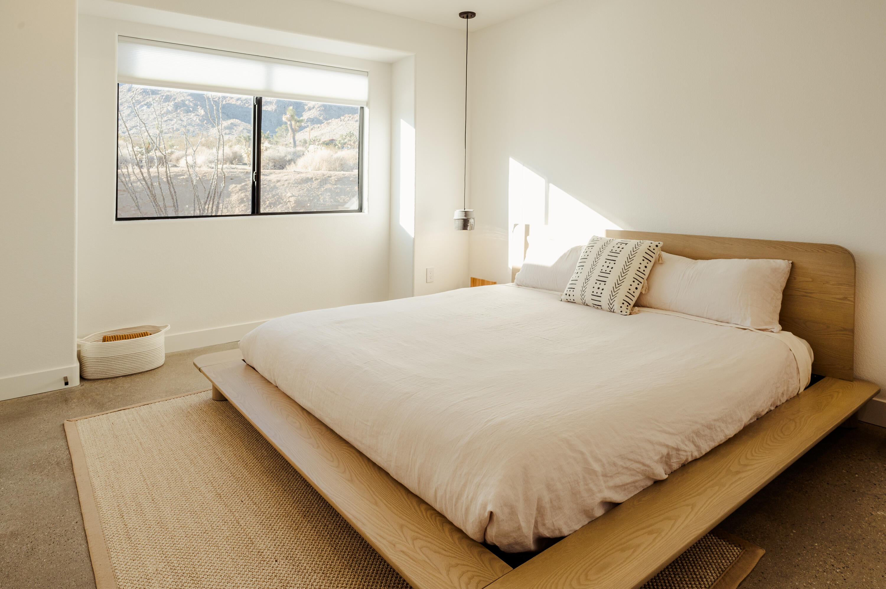 60633 Pueblo Trail Joshua Tree, CA 92252 - Photo 42 of 65 a large bed sitting in a bedroom next to a window