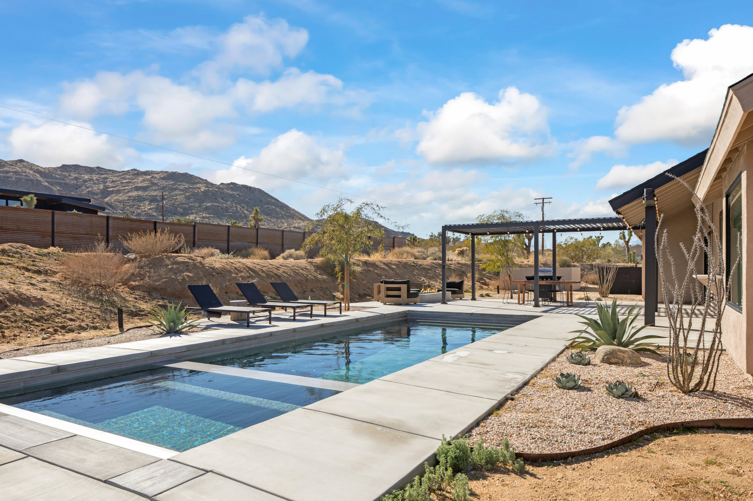 60633 Pueblo Trail Joshua Tree, CA 92252 - Photo 56 of 65 a view of a swimming pool with a lounge chair