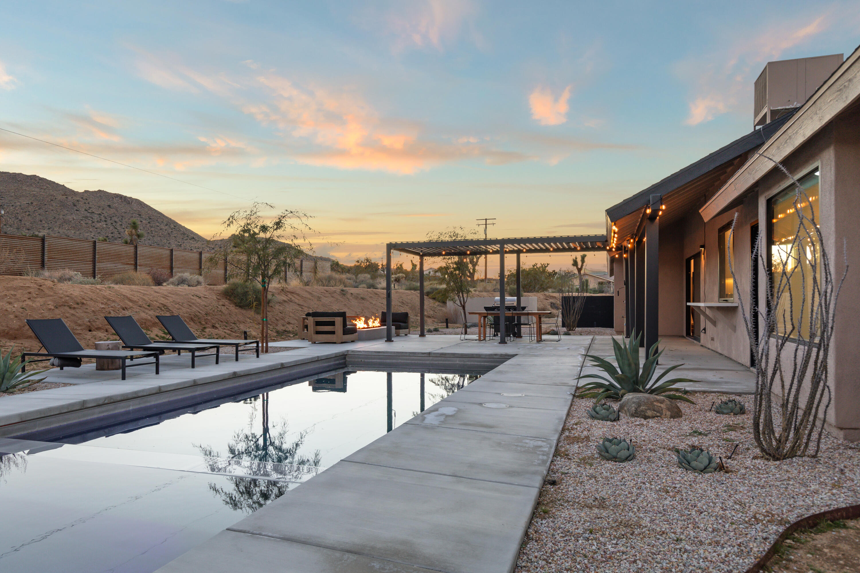 60633 Pueblo Trail Joshua Tree, CA 92252 - Photo 8 of 65 a view of a balcony with couches and sky view