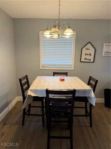 a dining room with a wooden table and chairs