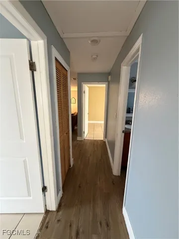 a view of a hallway with wooden floor and staircase