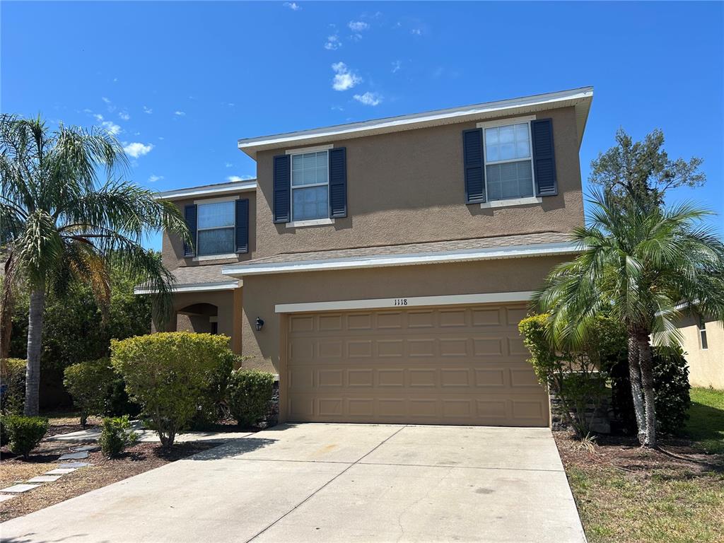 a front view of a house with garage