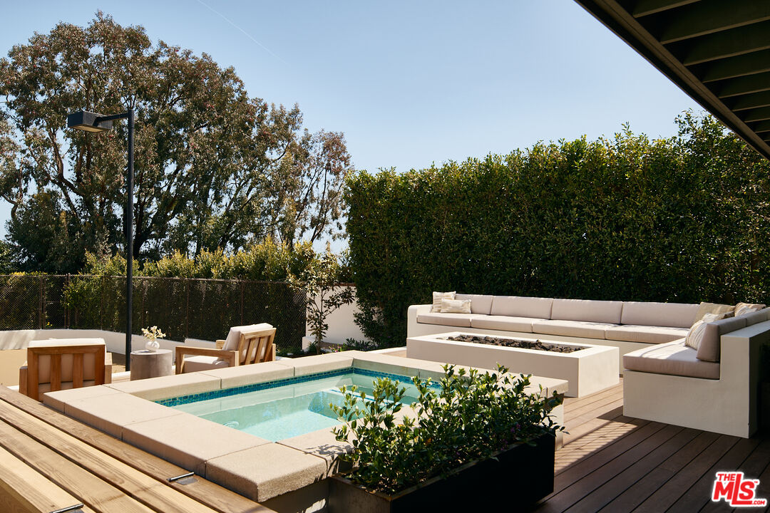 6930 Dume Drive Malibu, CA 90265 - Photo 17 of 34 a view of a table and chairs in patio of the house