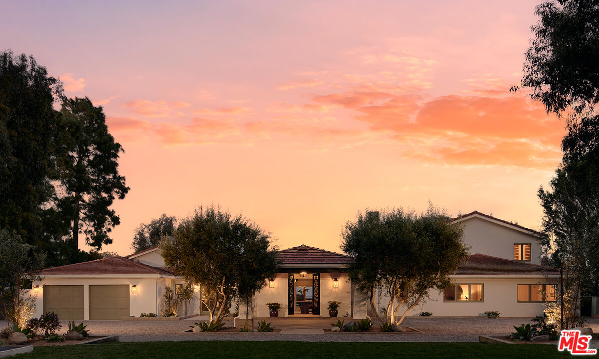 6930 Dume Drive Malibu, CA 90265 - Photo 2 of 34 a front view of a house with a yard