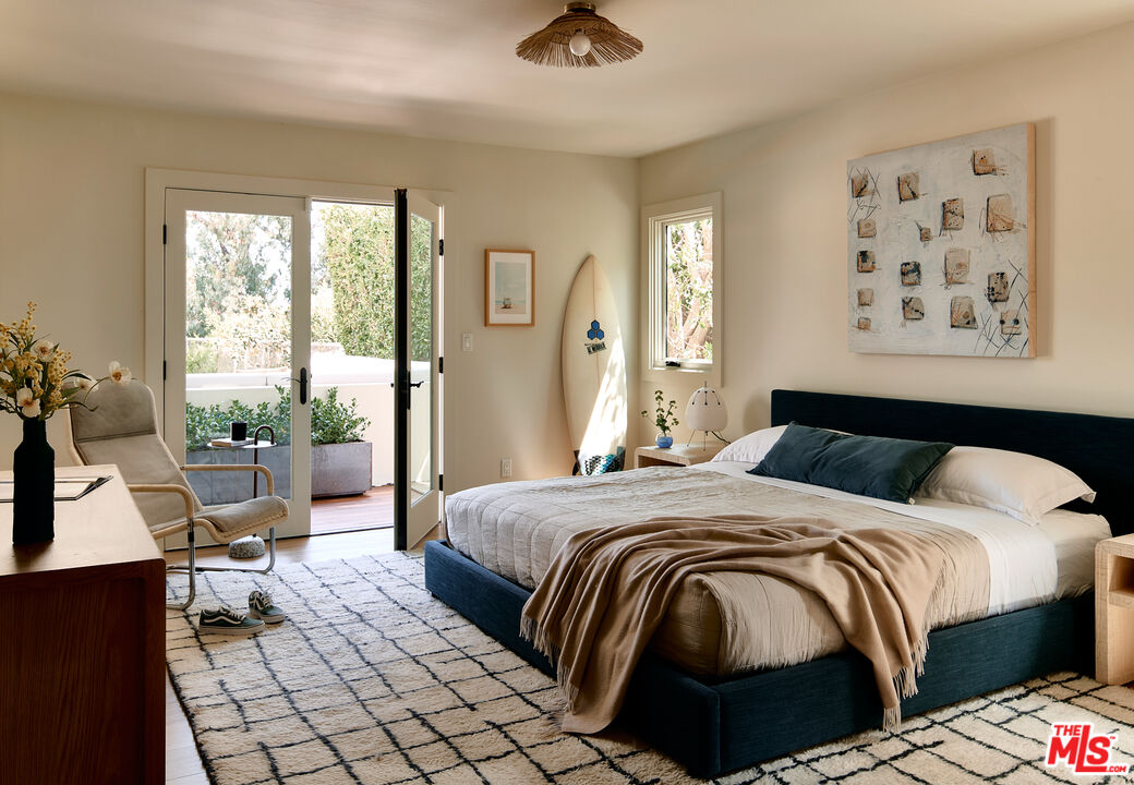 6930 Dume Drive Malibu, CA 90265 - Photo 26 of 34 a bedroom with a bed and a large window