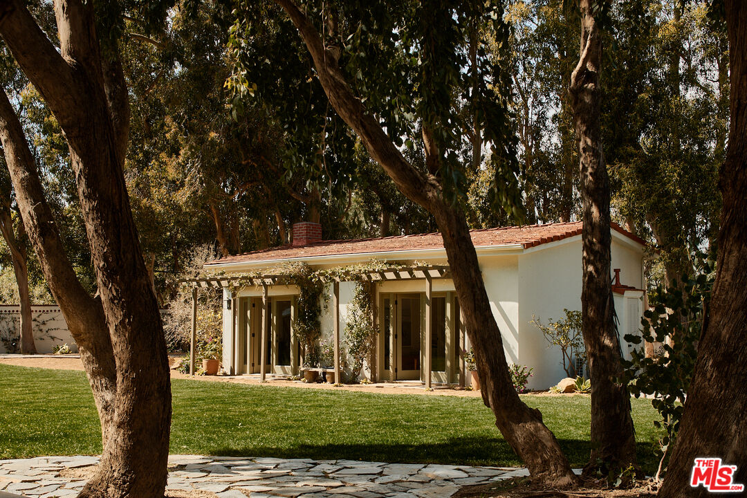 6930 Dume Drive Malibu, CA 90265 - Photo 29 of 34 a view of a house with a tree in a yard