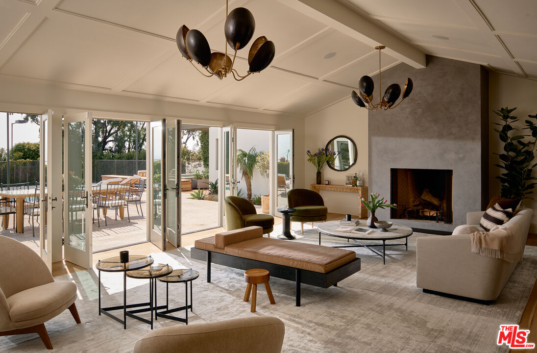 6930 Dume Drive Malibu, CA 90265 - Photo 3 of 34 a living room with patio furniture and a fireplace