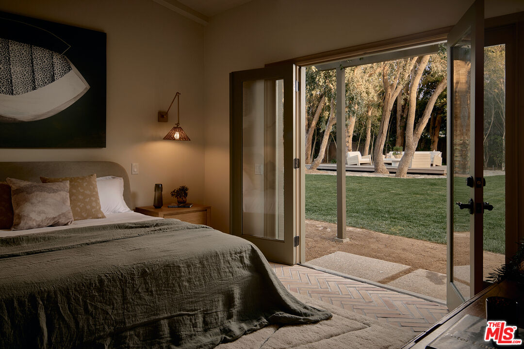 6930 Dume Drive Malibu, CA 90265 - Photo 31 of 34 a bedroom with a bed and a floor to ceiling window